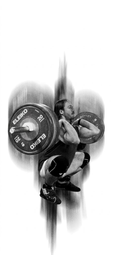 Athlete holding a loaded barbell in a deep front squat